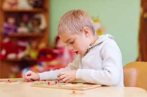 child completing a puzzle